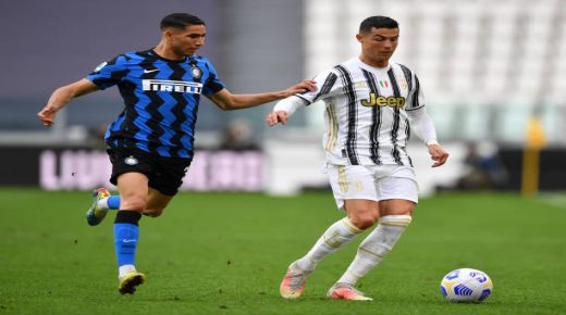 TURIN, ITALY - MAY 15: Cristiano Ronaldo of Juventus is challenged by Achraf Hakimi of FC Internazionale during the Serie A match between Juventus and FC Internazionale at Allianz Stadium on May 15, 2021 in Turin, Italy. Sporting stadiums around Italy remain under strict restrictions due to the Coronavirus Pandemic as Government social distancing laws prohibit fans inside venues resulting in games being played behind closed doors. (Photo by Valerio Pennicino/Getty Images)